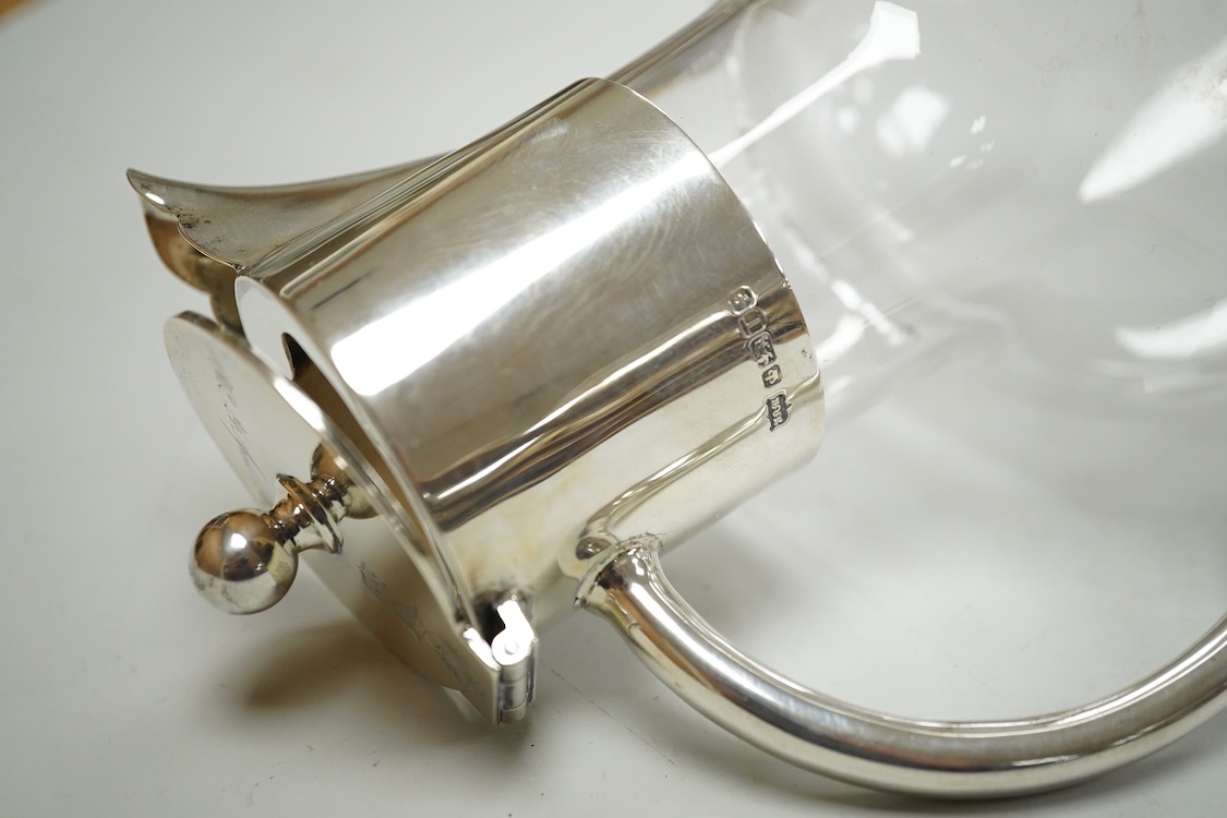 A late Victorian silver mounted glass claret jug, by John Newton Mappin, Sheffield, 1886, with engraved crest and anniversary dates, height 25.5cm.
